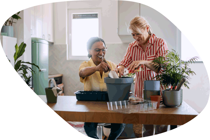 two women potting a plant